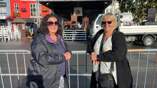 Women stood next to a barrier