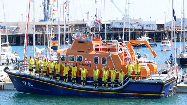 Lifeboat crew waving