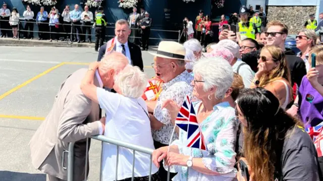 King being kissed on cheek by Guernsey resident Kathleen Moriarty