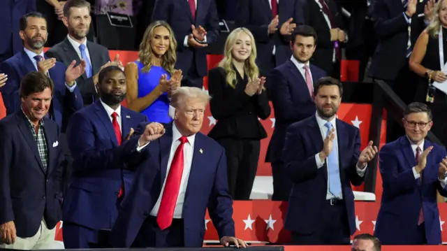 Republican presidential nominee and former U.S. President Donald Trump raises his fist as he arrives Day 1 of the Republican National Convention (RNC) at the Fiserv Forum in Milwaukee, Wisconsin