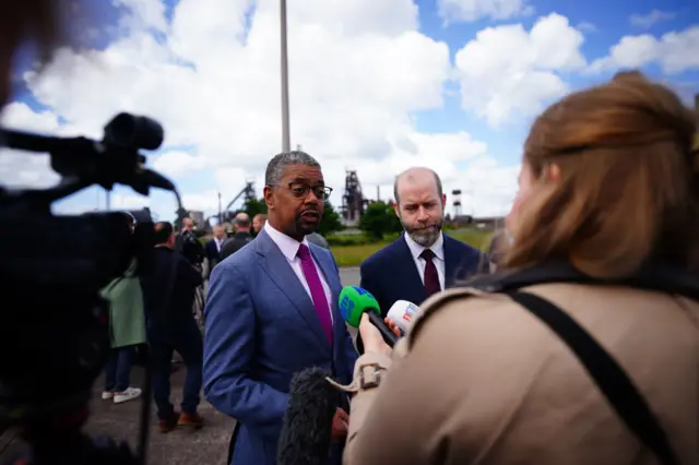 Vaughan Gething answering questions from reporters in front of the steelworks in Port Talbot