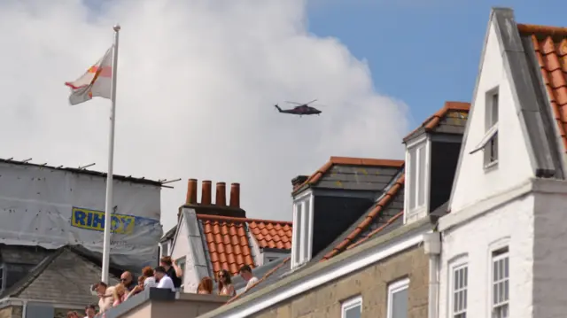 Helicopter seen above houses