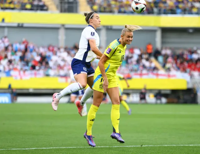 Bronze heads the ball above Rolfo