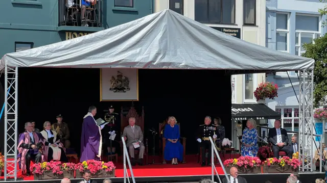 King and Queen on stage at St Peter Port for special states sitting