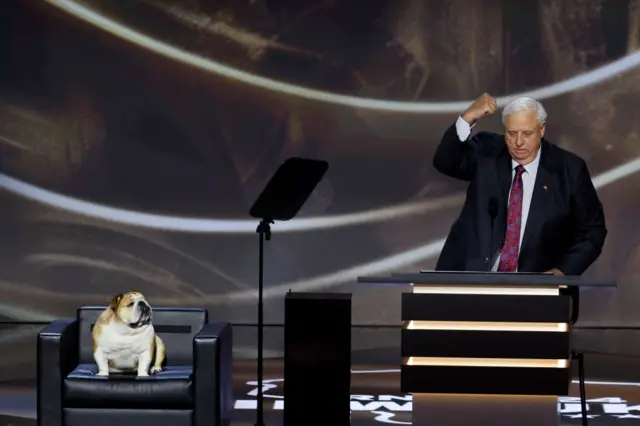 Babydog on stage with Gov. Jim Justice