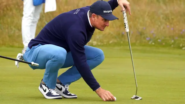 Justin Rose lines up a putt