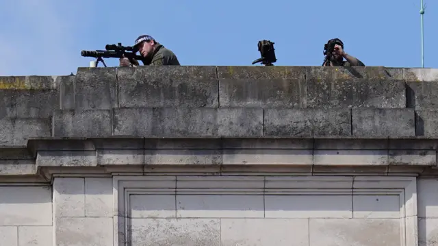 Police marksmen on the roof of Buckingham Palace, ahead of the King's Speech at the State Opening of Parliament in the House of Lords at the Palace of Westminster.