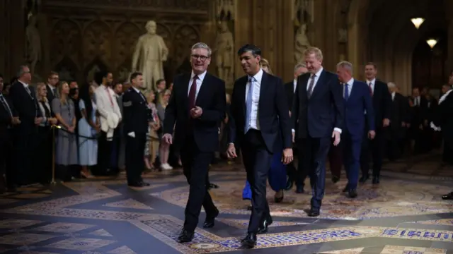 Prime Minister Sir Keir Starmer and former prime Minister Rishi Sunak lead MPs through the Central Lobby of the Houses of Parliament