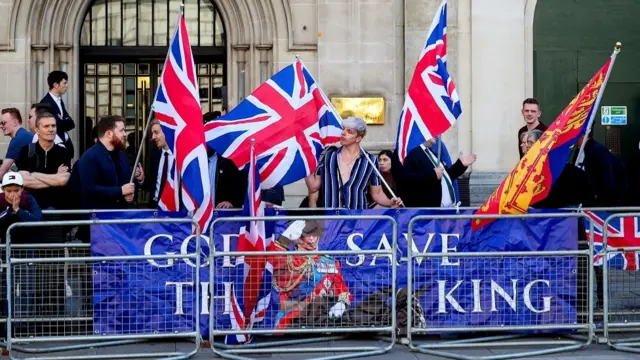 Pro-monarchy demonstrators hold placards near the Houses of Parliament on the day of the State Opening of Parliament in London, Britain July 17