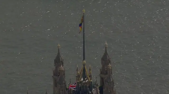 The union flag being lowered at the Palace of Westminster and replaced by the Royal Standard