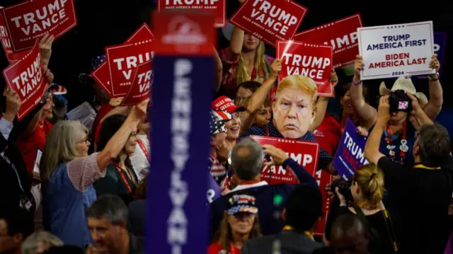 Attendees hold signs supporting Republican presidential candidate, former U.S. President Donald Trump and Republican vice presidential candidate, U.S. Sen. J.D. Vance