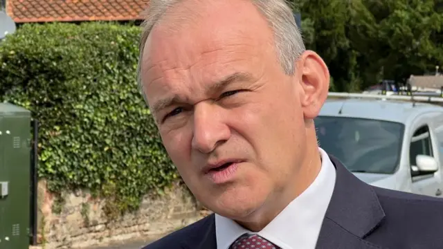 Headshot of Ed Davey in residential street