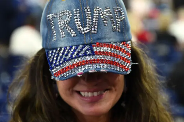 A woman wears a rhinestone-studded Trump baseball cap at the RNC