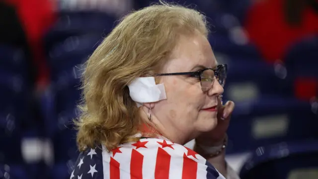 An attendee wears a bandage in reference to the injury suffered by Republican presidential nominee and former U.S. President Donald Trump in the assassination attempt, o