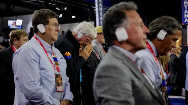 Arizona delegates wear bandages on their right ear in solidarity with Republican presidential nominee and former President Donald J. Trum