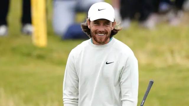 Tommy Fleetwood smiles during a practice round