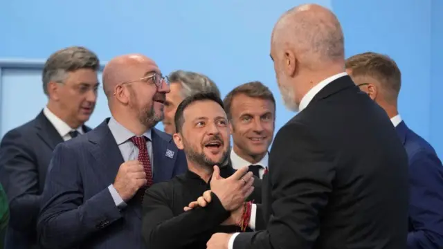 Prime Minister of Albania Edi Rama shakes hands with Ukrainian President Volodymyr Zelensky during the opening plenary