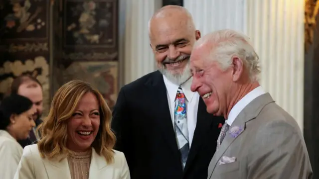 Prime Ministers of Italy and Albania laughing with King Charles