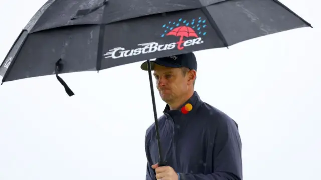 Justin Rose with an umbrella at Royal Troon