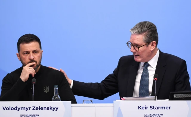 British Prime Minister Keir Starmer (R) gestures next to Ukrainian President Volodymyr Zelensky (L) during the Opening Plenary at the European Political Community (EPC) meeting at Blenheim Palace, in Woodstock, Oxfordshire