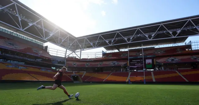 Sam Costelow practices kicks during training