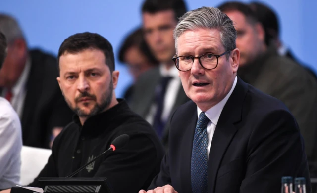 British Prime Minister Keir Starmer (R) and Ukrainian President Volodymyr Zelensky (L) attend the Opening Plenary at the European Political Community (EPC) meeting at Blenheim Palace, in Woodstock