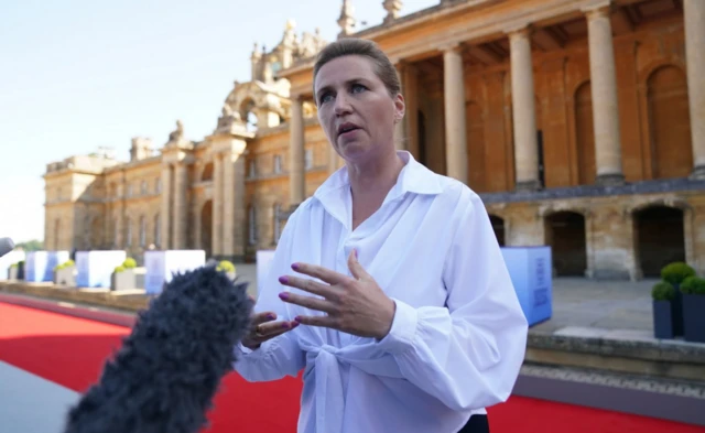 Prime Minister of Denmark Mette Frederiksen speaks to the media as she arrives to attend the European Political Community summit at Blenheim Palace in Woodstoc