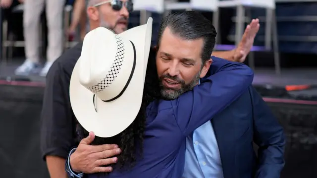 Donald Trump Jr hugging an attendee