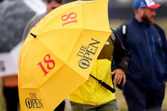 A fan with an umbrella at Royal Troon