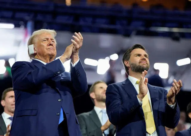 Donald Trump and JD Vance standing and applauding