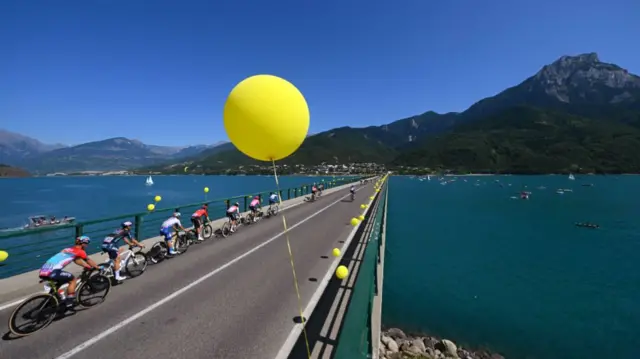 Cyclists ride across a bridge on stage 18 of the 2024 Tour de France