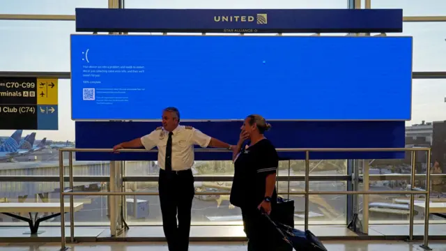 A blank screen on a departure board shows the impact of IT outages