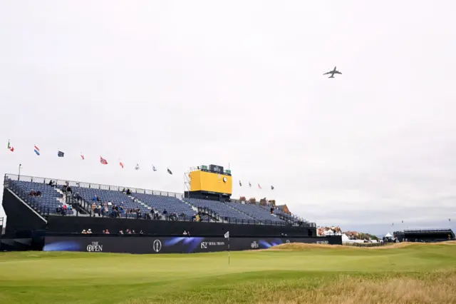 An aeroplane over the top of a hole at Royal Troon