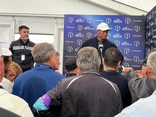 Tiger Woods faces the media after round two