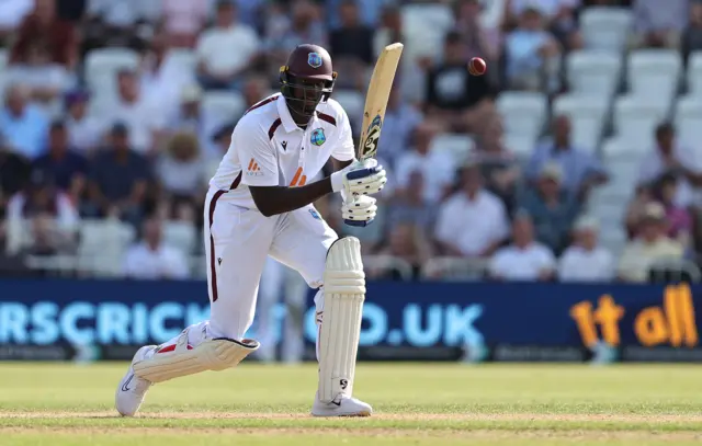 Jason Holder plays a shot