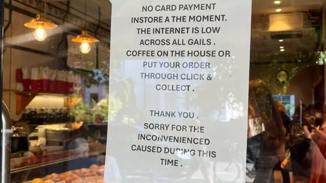 Picture of a sign on window of bakery