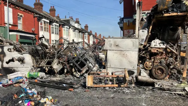 Burnt out bus on street