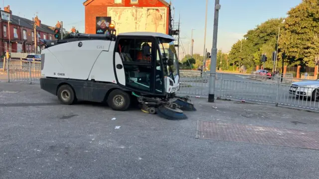 A street cleaning truck making its way on the street