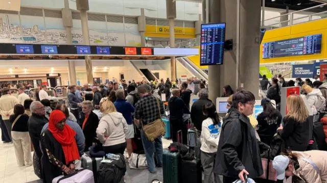 People stand about at Brisbane airport