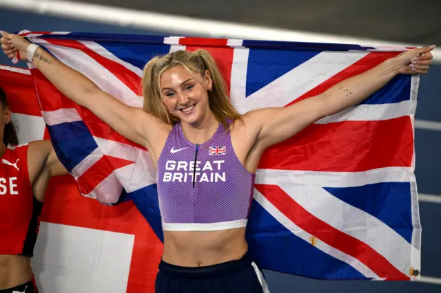 Molly Caudery holds the Union Jack flag behind her back