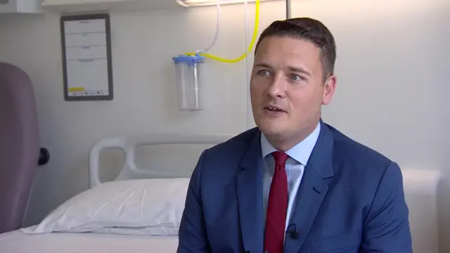 Wes Streeting being interviewed in a hospital