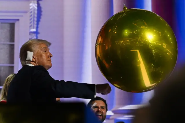 Trump with a golden balloon