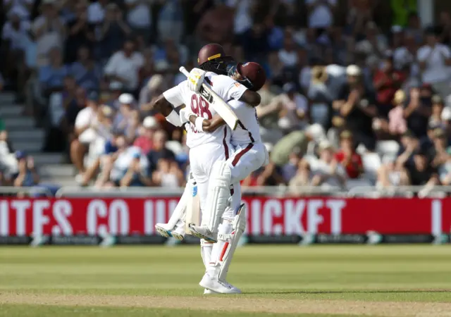 West Indies' Kavem Hodge (right) celebrates 100 runs during day two of the Second Rothesay Test match at Trent Bridge, Nottingham