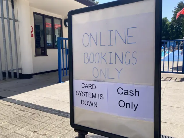 A sign outside the Droitwich Spa Lido that says 'card system is down, cash only'