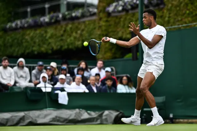 Giovanni Mpetshi Perricard strikes the ball with a right handed forehand