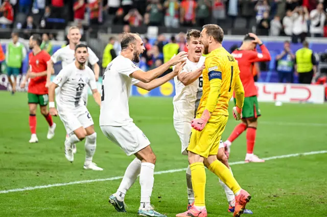 Jon Gorenc Stankovic of Slovenia, Jaka Bijol of Slovenia and goalkeeper Jan Oblak of Slovenia celebrate after the saved penalty