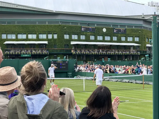 Jacob Fearnley at the net after winning