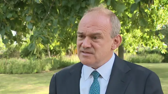 Ed Davey speaks to a reporter