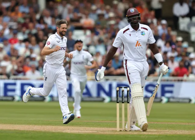 Chris Woakes celebrates as Jason Holder walks off after being dismissed