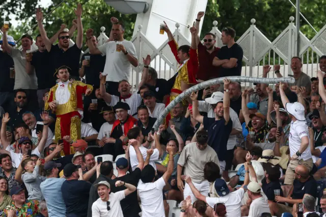 England fans build a beer snake on the third day of the second Test cricket match between England and West Indies at Trent Bridge in Nottingham